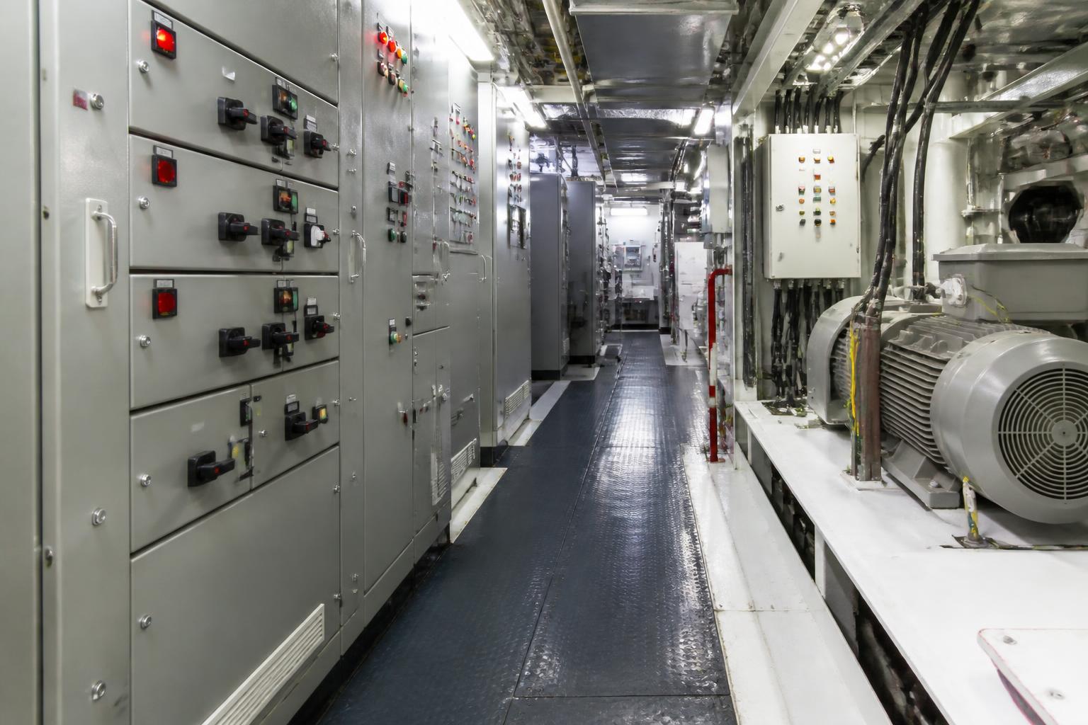 Marine electrical room with switchboards, circuit breakers and motors